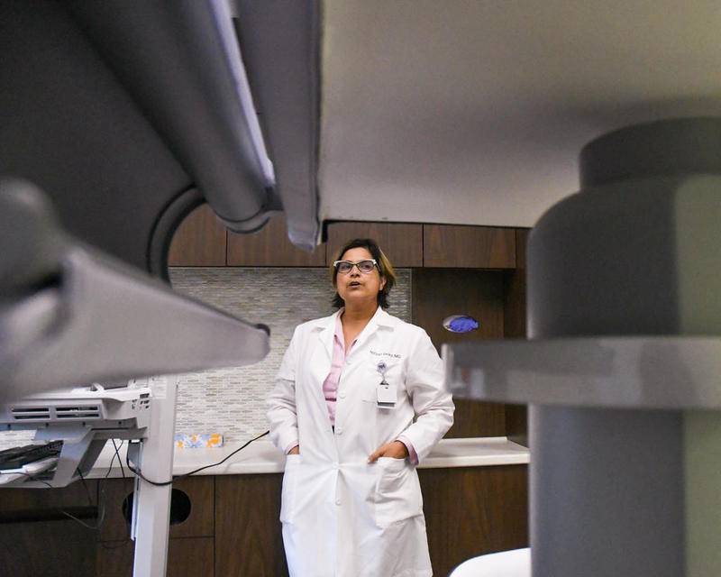 Dr. Nitzet Velez explains how the new stereotactic machine works during an open house held Monday at Northwestern Medicine Kishwaukee Hospital.