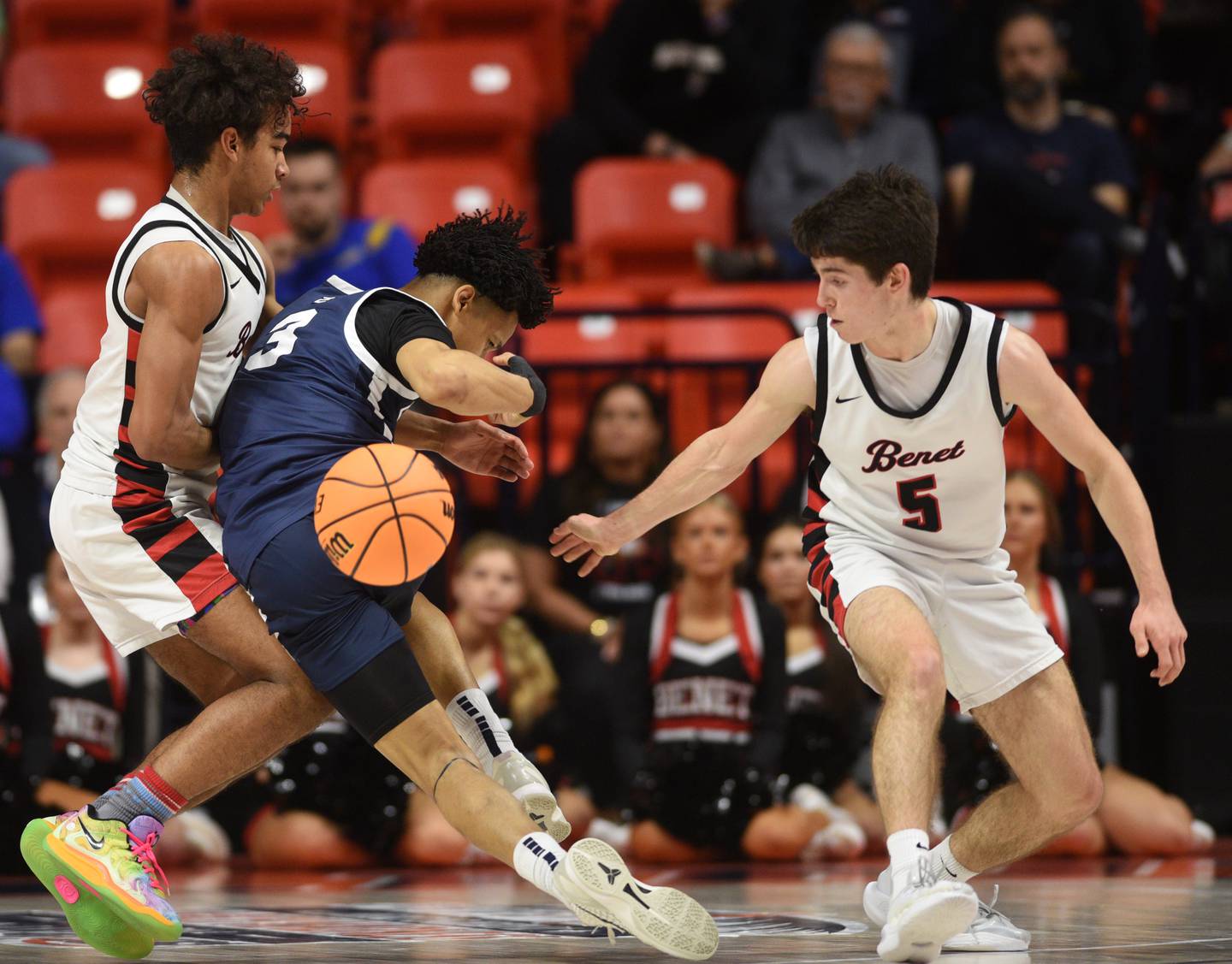 Benet Academy's Michael Doyle , right, grabs the ball after Evanston's Kaidan Chatham, middle, ran into the Redwings’ Blake Fagbemi during the IHSA Class 4A boys basketball state semifinals at State Farm Center on Friday, March 14, 2025 in Champaign.