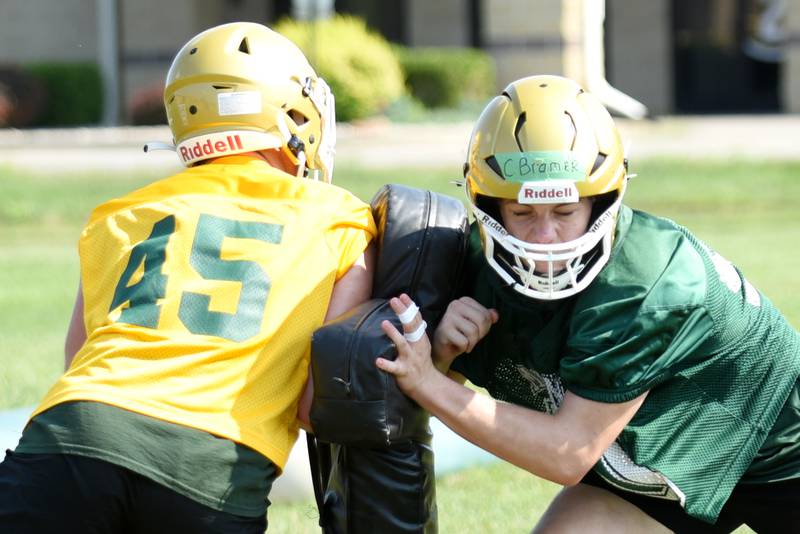 Bishop McNamara's Cullen Bramer, right, engages with Michael Clark during a drill at practice Monday, Aug. 11, 2025.