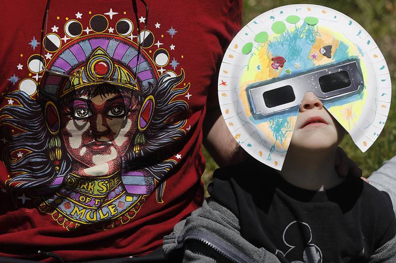 Owen Galiotto, 3, watches the partial eclipse Monday, April 8, 2024, at the Crystal Lake Park District's Nature Center.