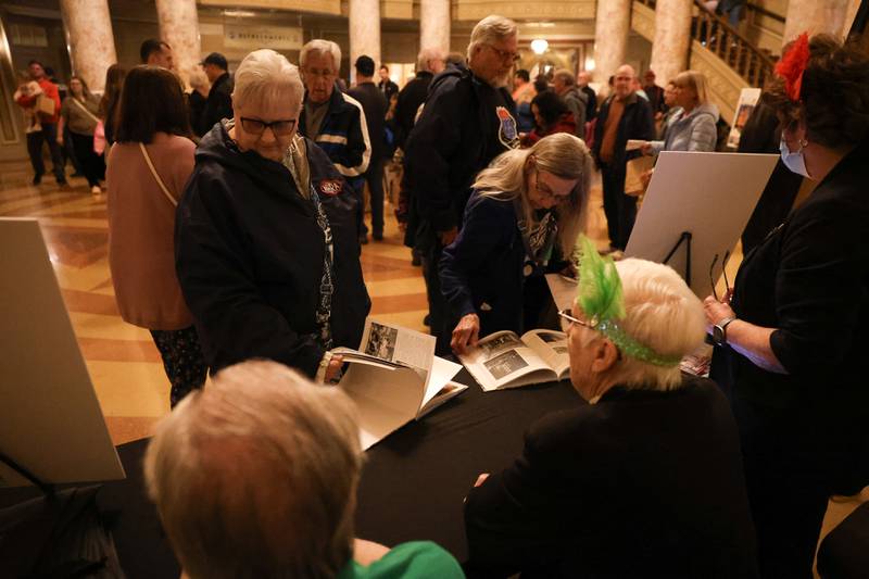 Guest look at the Rialto Theater centennial book at the Rialto Theater’s 100th anniversary celebration on Sunday, May 3, 2026 in Joliet.