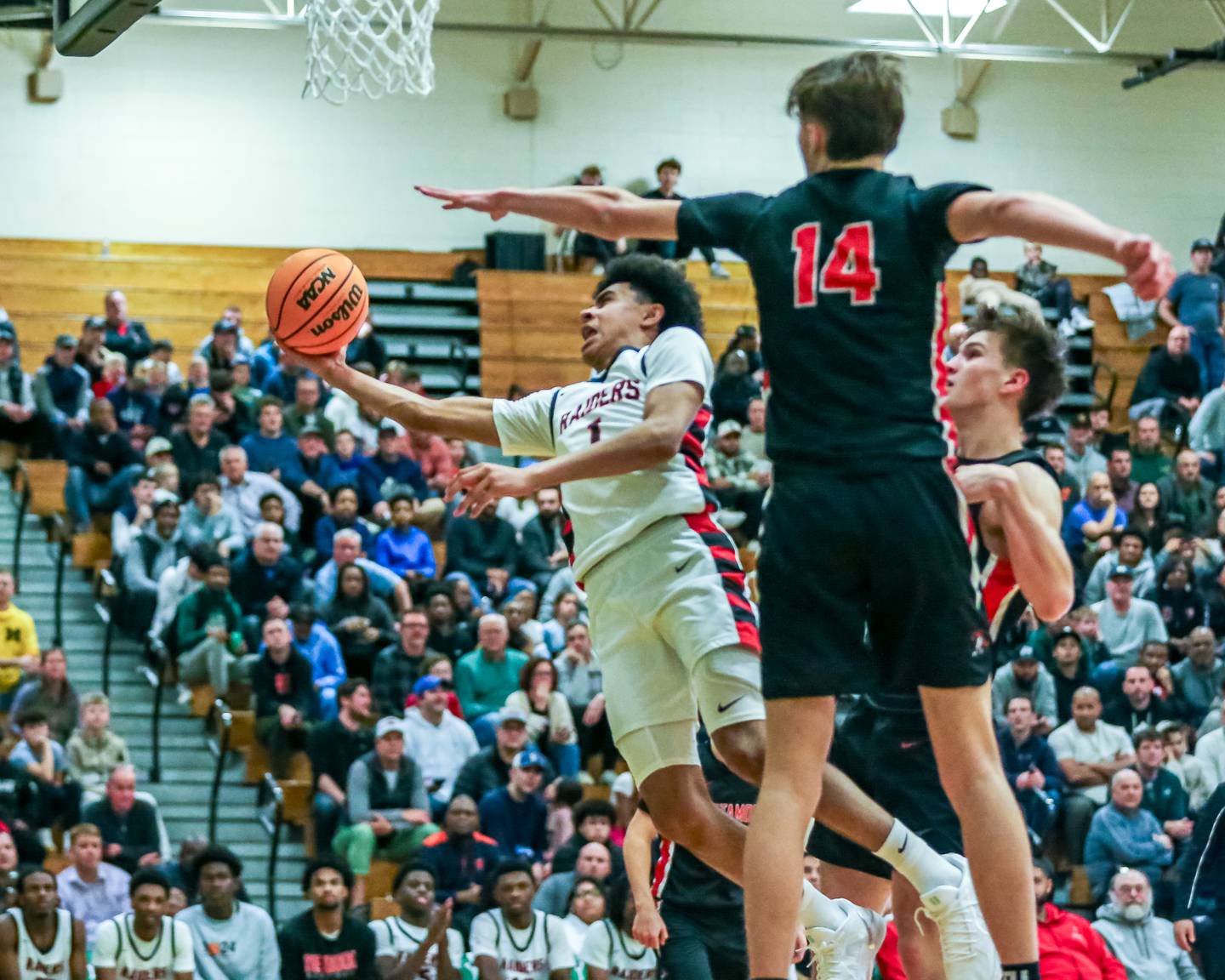 Bolingbrook's Braden Pettigrew (1) goes underneath on a shot attempt during their Jack Tosh Holiday Classic basketball tournament game between Bolingbrook at Metamora. Tuesday Dec 30, 2024 in Elmhurst.