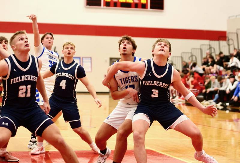 Fieldcrest's Jackson Hakes (21), Lucas Anson (4) and Eddie Lorton (3) box out on a shot from Jordan Reinhardt Tuesday night at Hall High School. The Knights won 47-43.