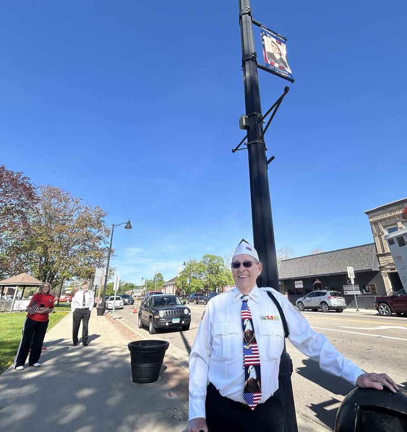 Oregon veteran Lee Ossmann stands near the Hometown Hero banner that was installed on Thursday, April 23, 2026 on a city street pole in downtown Oregon.