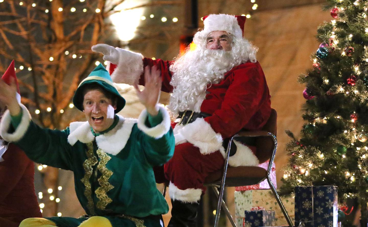 Santa Claus and his elves wave to the crowd as they parade down Lincoln Highway Thursday, Dec. 2, 2021, during Lights on Lincoln and Santa Comes to Town.