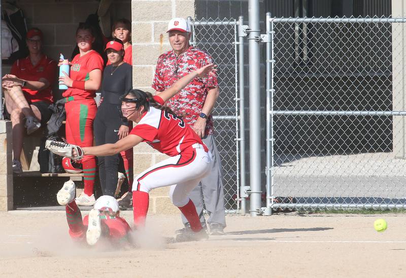 L-P's Maggie Boudreau slides into third base as the ball gets away from Streator's Mya Zavada during the Class 3A Regional semifinal game on Tuesday, May 27, 2025 at Pontiac High School.