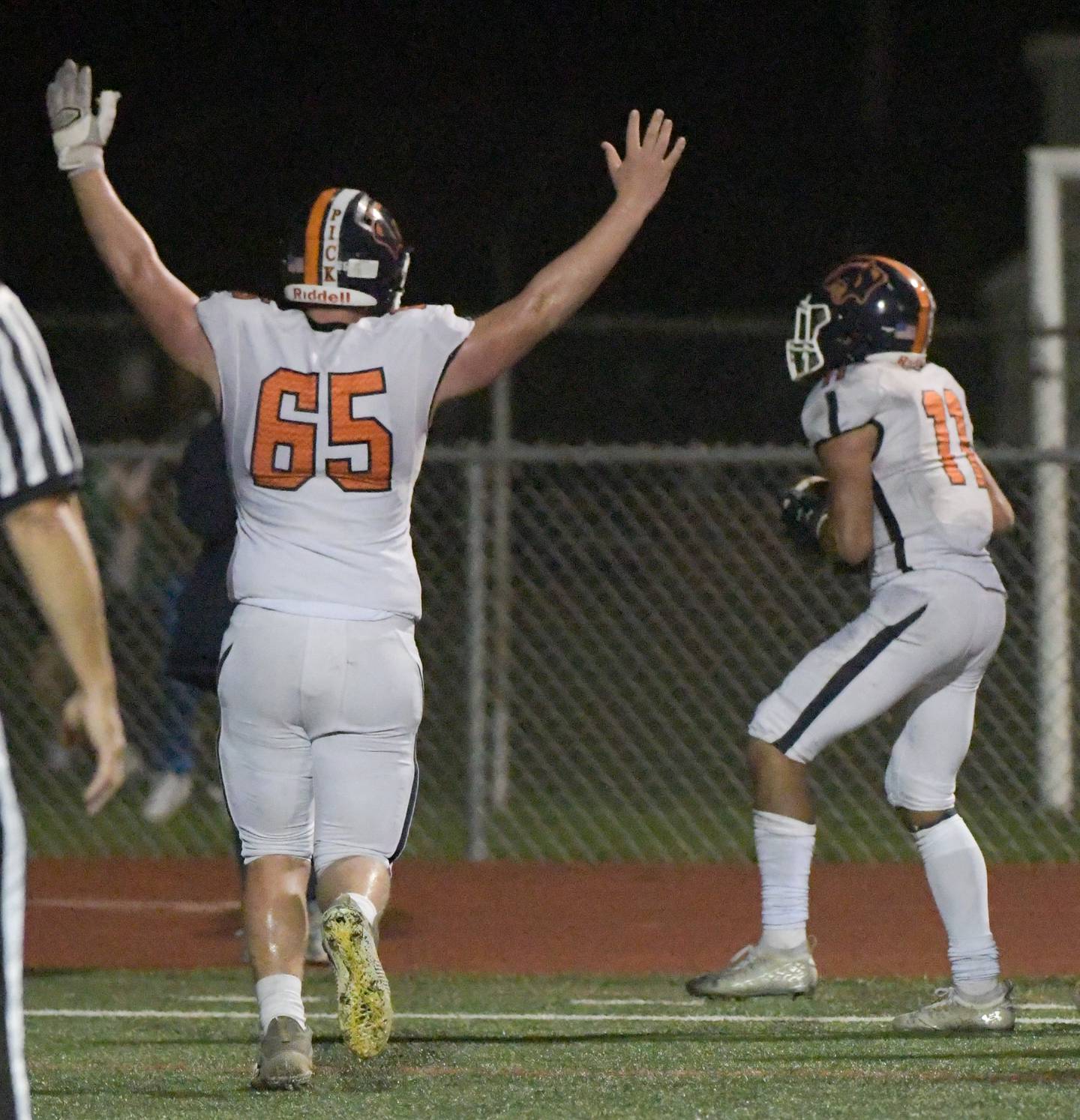 Oswego's Max Castle (65) celebrates as Mark Melton (11) enters the end zone for a fourth quarter touchdown against West Aurora during a game in Aurora on Friday, October 8, 2021.