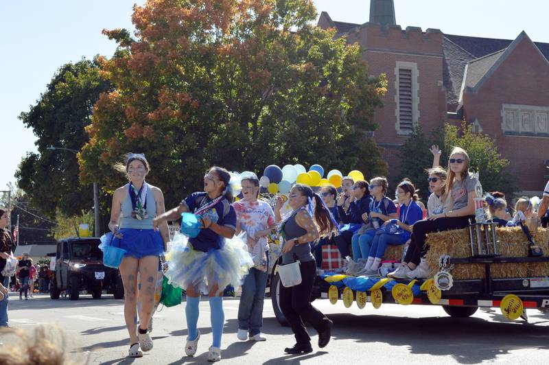 Members of the Oregon Avalanche softball team throw candy to the crowd at the Harvest Time Parade on Sunday, Oct. 6, 2024, during the 53rd annual Autumn on Parade in Oregon.