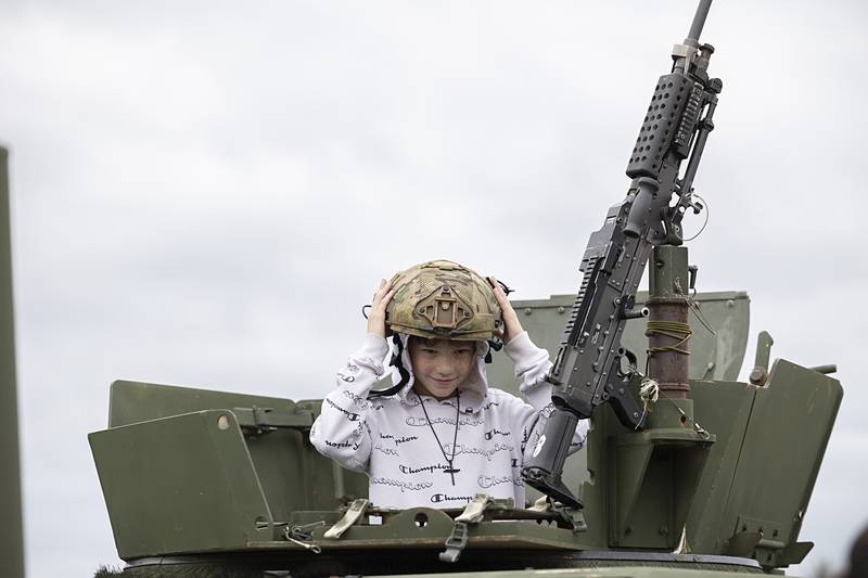 Owen Scribner, 10, checks out a tactical helmet and Humvee Tuesday, Aug. 6, 2024 during National Night Out in Dixon. The Dixon Police Department hosted the event in the parking lot of Wooden Wonderland.