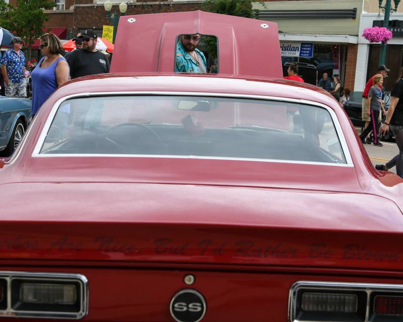 Dean Duriavich of Waterman looks over a 1968 Chevrolet Camaro during the 24th annual Fizz Ehrler Memorial Turning Back Time Car Show held in downtown Sycamore on Sunday, July 28, 2024.