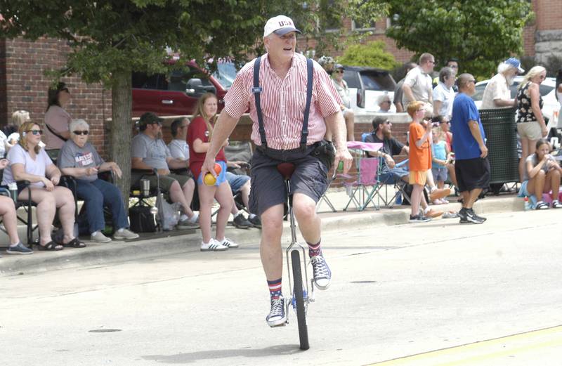 A unicyclist entertains parade-goers Sunday, July 6, 2025, at the 61st annual Dixon Petunia Fest.