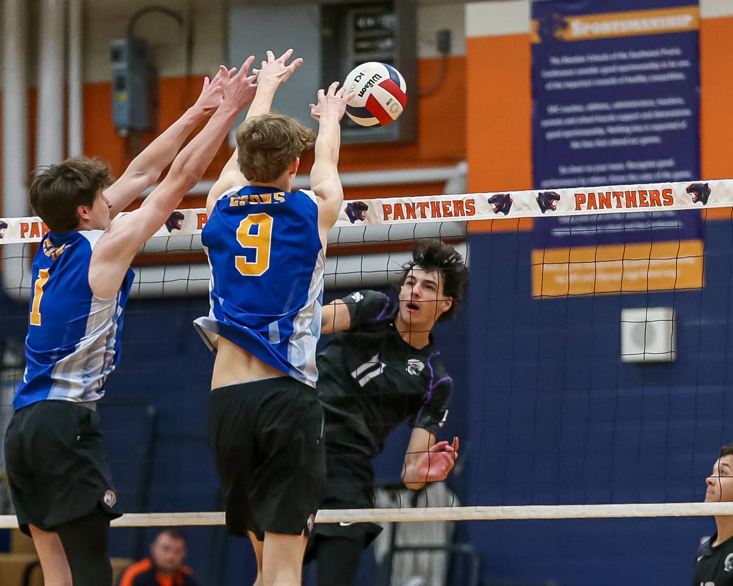 Lyons Connor Carroll (1) and Leo Wiemelt (9) block a spike attempt by Downers Grove North's Aiden Akkawi (11) during Oswego Sectional final between Downers Grove North at Lyons.  May 30, 2023.