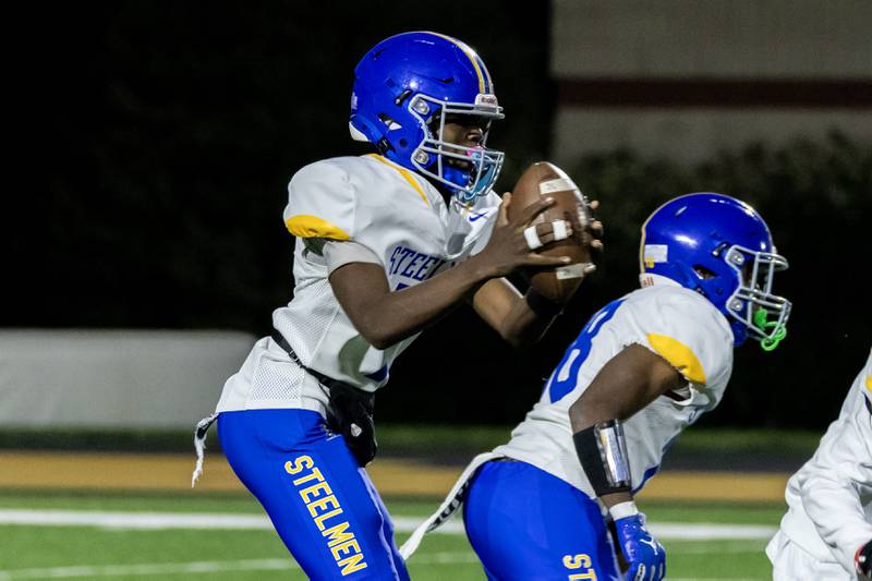 Joliet Central's Jeffrey Woods looks for an open teammate during a varsity football game against Joliet West at Joliet West on Oct. 24, 2025.