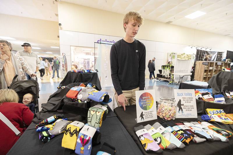 Sammy Francque mans his booth Sock Valley Wednesday, April 26, 2023. Francque of Newman high, offers a wide variety of sock designs.