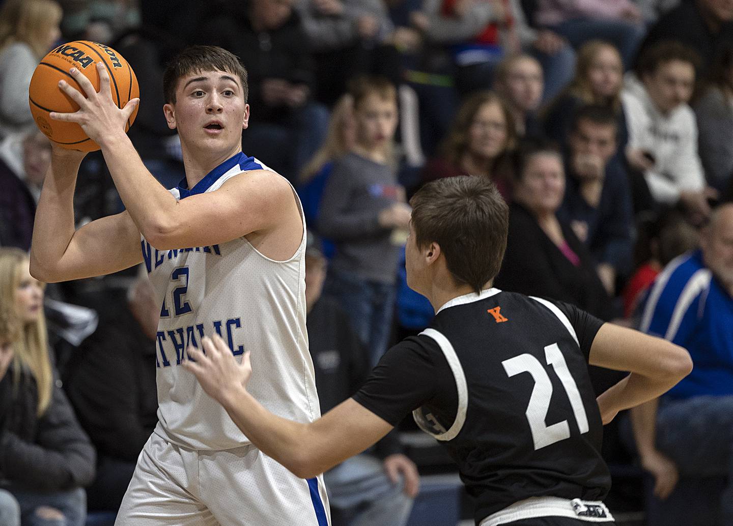 Newman’s Evan Bushman looks to pass against Kewanee’s Abram Hicks Friday, Jan. 10, 2025.