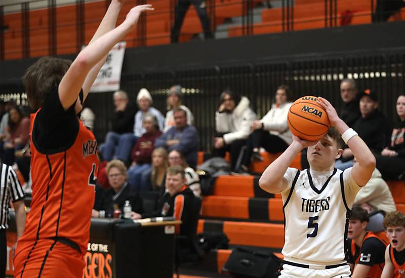 Crystal Lake Central's JR Mason launch a three point shot as McHenry's Nate Ottaway rushed Mason during a Fox Valley Conference boys basketball game on Tuesday, February. 10, 2026, at Crystal Lake Central High School.