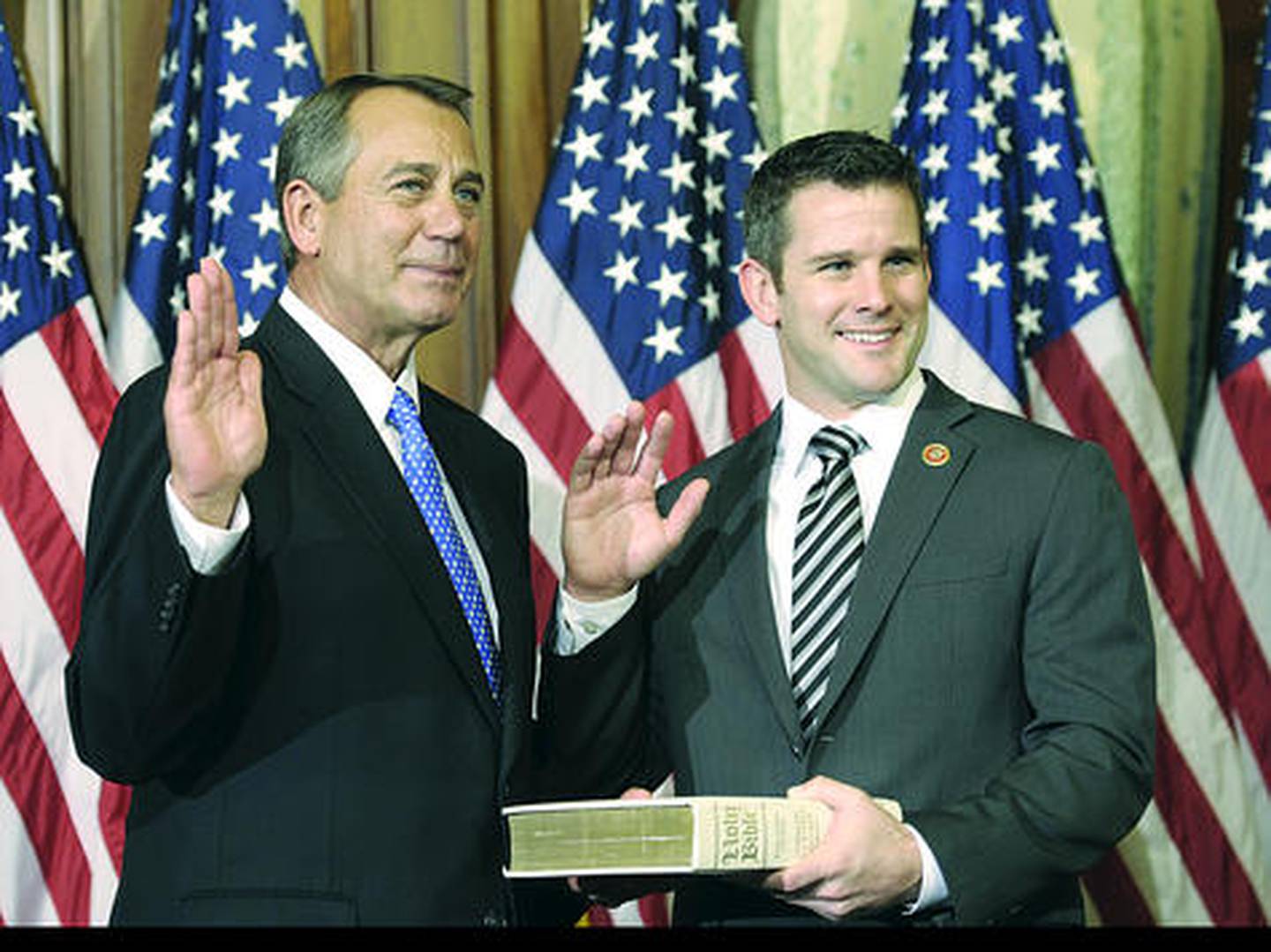 House Speaker John Boehner of Ohio (left) performs a mock swearing in for Rep. Adam Kinzinger on Thursday on Capitol Hill in Washington as the 113th Congress began. Kinzinger now represents the 16th Congressional District.