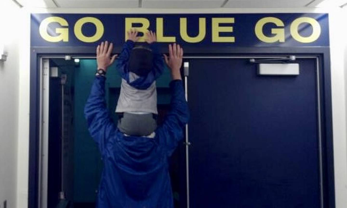 Tommy Fraumann rides on top of the shoulders of his father, former Michigan football player Bob Fraumann.