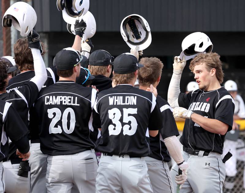 Kaneland's Parker Violett (right) is greeted at home after hitting a three-run homer during their game against Sycamore Monday, April 22, 2024, at the Sycamore Community Sports Complex.