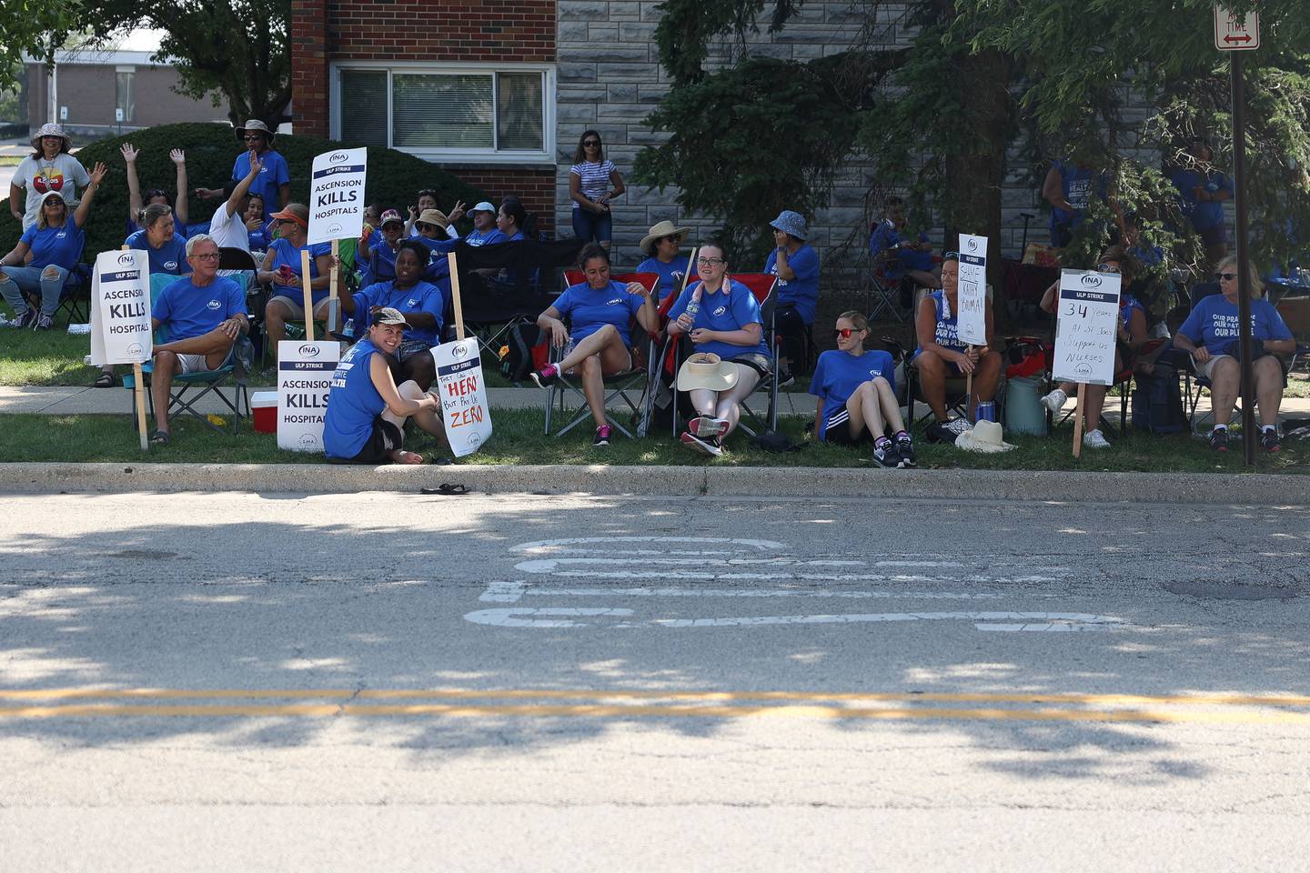 Picketers take shade to protest outside Ascension Saint Joseph-Joliet hospital on Thursday, Aug. 24, 2023.