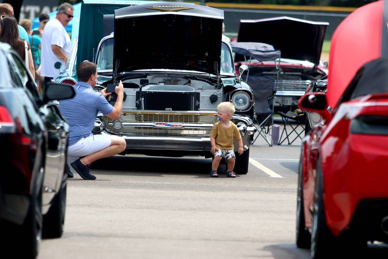 Miles Buchanio, 2, of Barrington strikes a macho pose in front of a classic Chevrolet as his dad Michael makes a picture during Fiesta Days at Petersen Park in McHenry Sunday.