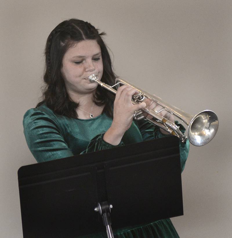 Grace Eitutis, a senior at La Salle-Peru High School, performs on the trumpet Friday, Nov. 11, 2022, before receiving an award at the Grand Bear Lodge in Utica during the NCI ARTworks Mad Hatter’s Ball.