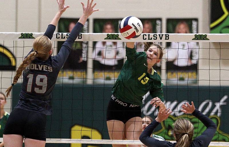 Crystal Lake South’s Logan Georgy, right, sends the ball past Prairie Ridge’s Ashley Stiefer in varsity volleyball at Crystal Lake South Tuesday night.