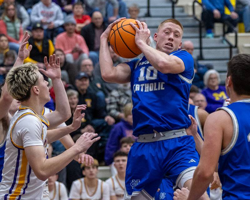 Newman's George Jungerman (10) retrieves rebound in game against Mendota on Friday, January 30, 2026 at Mendota High School in Mendota.