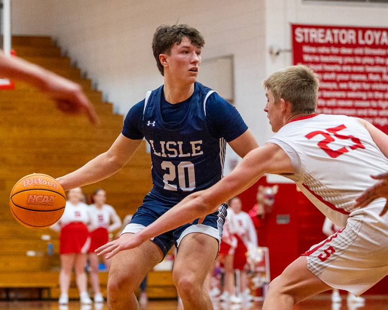 Lisle's Hunter Mcgrath (20) dribbles ball as Joseph Hoekstra (25) of Streator guards on Wednesday, Feb. 18, 2026 at Streator High School in Streator.