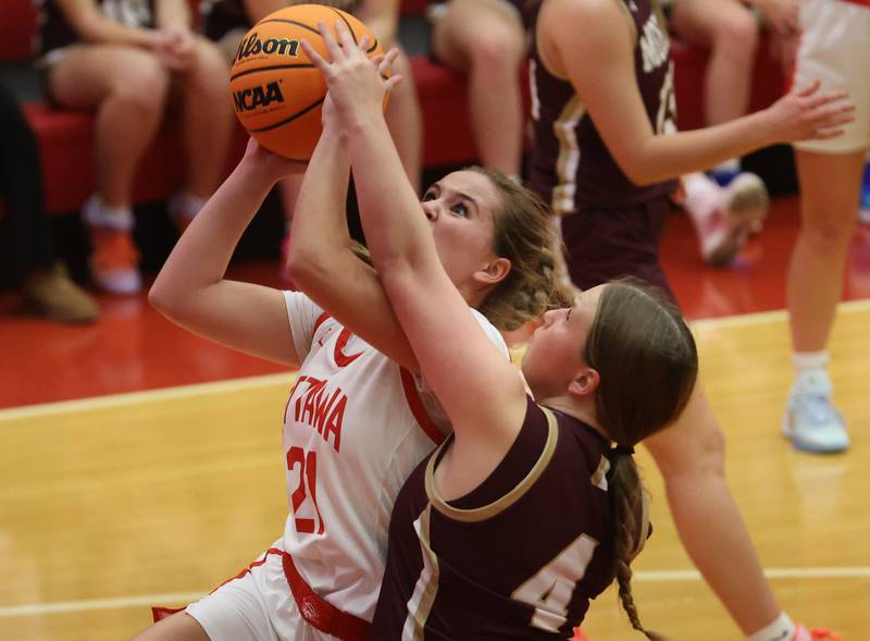 Ottawa's Hailey Thrush eyes the hoop as Morris's Brooke Thorson draws a foul on the arm on Tuesday, Dec. 9, 2025 in Kingman Gymnasium at Ottawa High School.