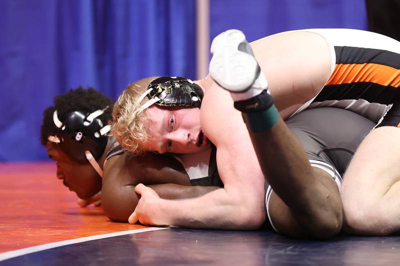 Dekalb’s Bryson Buhk looks to the coaches during while working over Mt. Carmel’s Elliot Lewis in the Class 3A 195lb. 3rd place match at State Farm Center in Champaign. Saturday, Feb. 19, 2022, in Champaign.