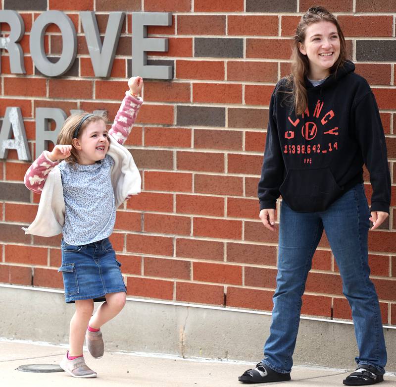 Kindergartener Charley Hollis dances to the music with her mom Sarah Curry Thursday, Aug. 21, 2025, as they arrive for the first day of school at North Grove Elementary School in Sycamore.