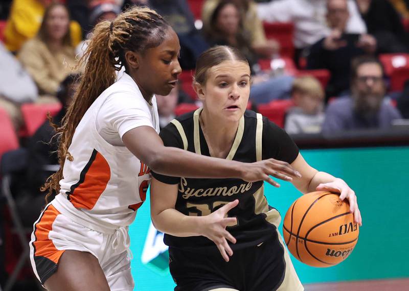 Sycamore's Quinn  Carrier drives against DeKalb's Me'She Eubanks Friday, Jan. 30, 2026, during their game in the FNBO Challenge in the Convocation Center at Northern Illinois University in DeKalb.
