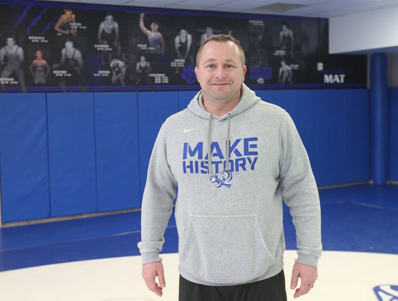 Princeton wrestling head coach Steve Amy poses for a photo in the wrestling room on Wednesday, March 12, 2025 at Princeton High School.