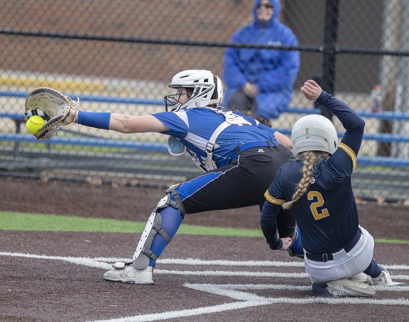 Sterling’s Madison Birdsley slides in safe at home against Quincy Tuesday, March 31, 2026.