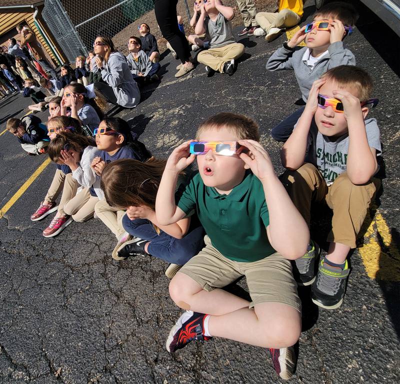 Second grade students from St. Michael the Archangel Catholic School in Streator watch Monday's solar eclipse in amazement.