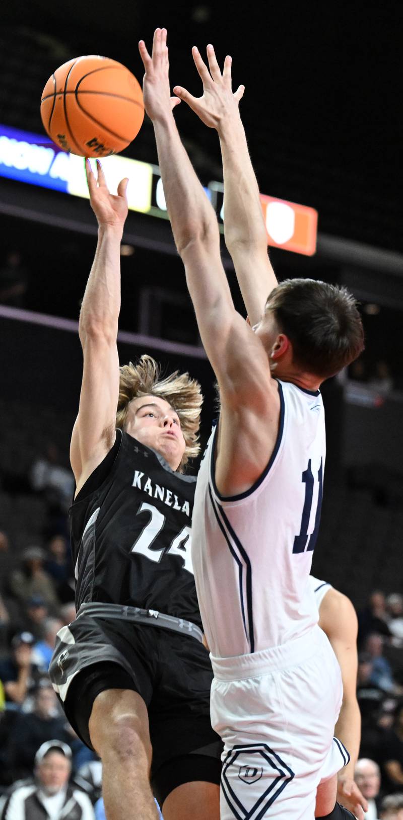 Kaneland's Luke Reinert shoots in front of DePaul College Prep defender Jonas Johnson during the Class 3A boys supersectional at NOW Arena on Monday, March 10, 2025 in Hoffman Estates.