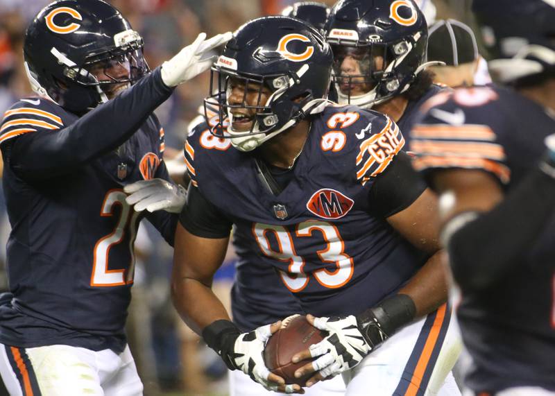 Chicago Bears running back Ian Wheeler, gets a pat on the helmet from teammate Travis Homer, after scoring a touchdown on Sunday, Aug. 17, 2025 at Soldier Field in Chicago.