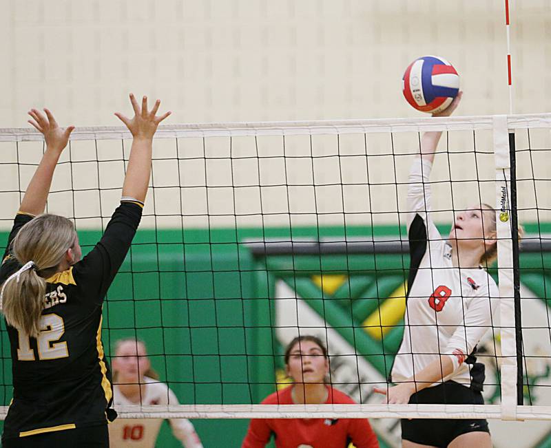 Henry's Talur Homann (8) spikes theball past Putnam County's Tori Balma (12) in the Tri-County Conference Tournament on Monday, Oct. 10, 2022 in Seneca.