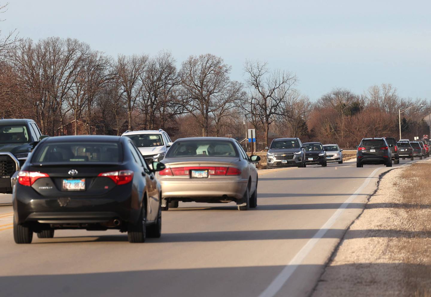 Vehicles travel down Peace Road just north of State Route 64 Tuesday, Jan. 7, 2025, in Sycamore. The DeKalb County Highway Department is seeking funds to widen the road and replace a bridge at this location.