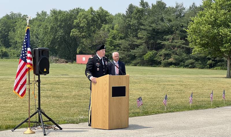 Former Sycamore Mayor Curt Lang stands as retired U.S. Army Lieutenant Colonel David Dosier speaks during the 2023 Flag Day Celebration on June 14, 2023.