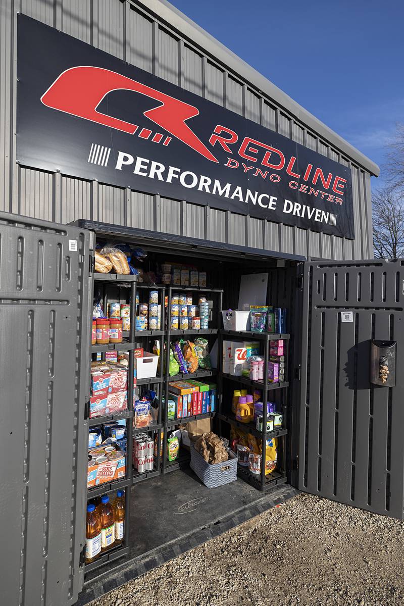 A free pantry sits outside of Redline Performance in Sterling Tuesday, Jan. 13, 2026, Cam and Courtney Plotner set up the shed for those who need a little extra help on food and hygiene staples. The pantry contains things like canned and boxed foods, soaps and pet food.