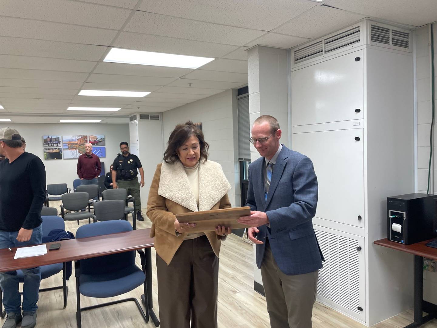 Utica Mayor David Stewart (right) presented executive administrative assistant Kathy Lewis with a plaque recognizing her 20 years’ service to the village at the May 9, 2024, board meeting.