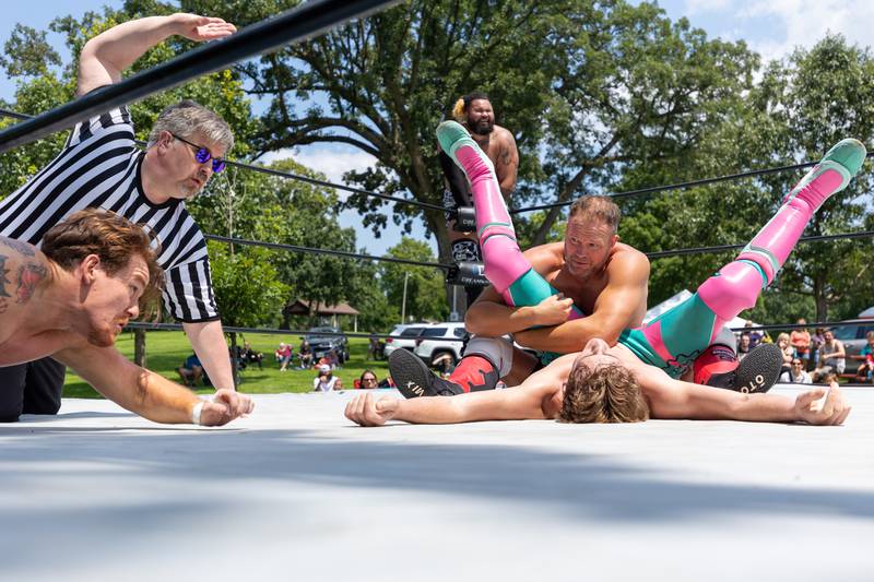 (left to right) Jay Marston attempts to breakup pin as Jason Pemberton counts pinfall made by Christian Rose to Jake Bosche at the Taste of the Illinois Valley DreamWave Wrestling event on Saturday, August 2, 2025 at Centennial Park in Peru.
