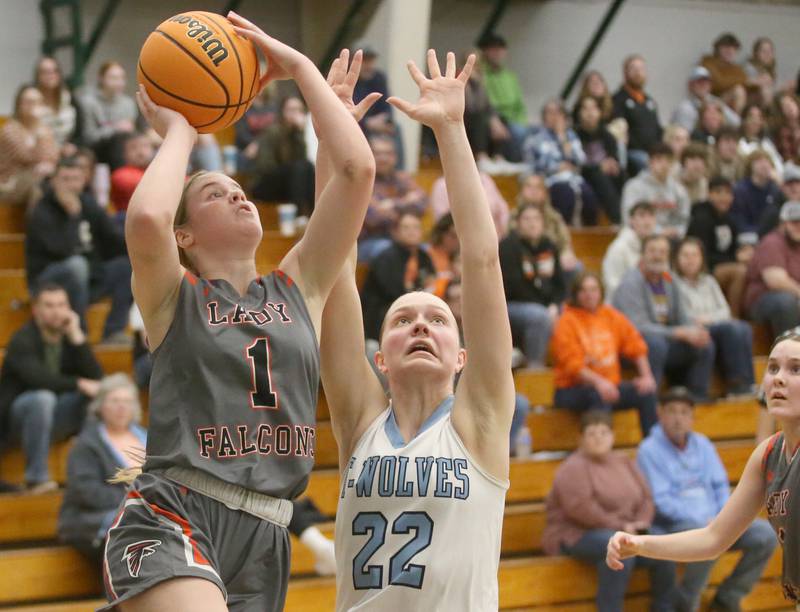 Flanagan-Cornell/Woodland's Ella Derosset eyes the hoop as Cissna Park's Josie Neukomm defends during the Class 1A Sectional semifinal game on Tuesday, Feb. 25, 2025 at Midland HIgh School.