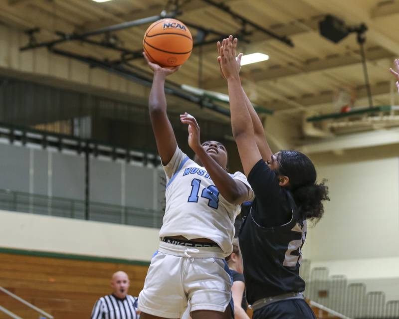 Downers Grove South's Abby Gray (1) puts up a shot during their York Thanksgiving Tournament matchup between Oswego East at Downers Grove South Friday, Nov 20, 2025 in Elmhurst.