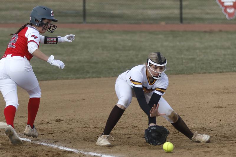 Jacob’s Avarie Lohrmann fields the ball as Palatine’s Angie Delgado runs back to third base during a non-conference softball game Monday, March 20, 2023, at Palatine High School.