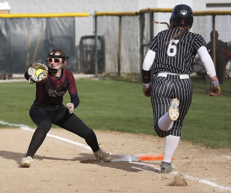 Prairie Ridge's Mary-Kate Center fields the ball to get out Crystal Lake Central's Harper Wright as first base during a Fox Valley Conference  softball game on Monday, April 20, 2026, at Prairie Ridge High School.