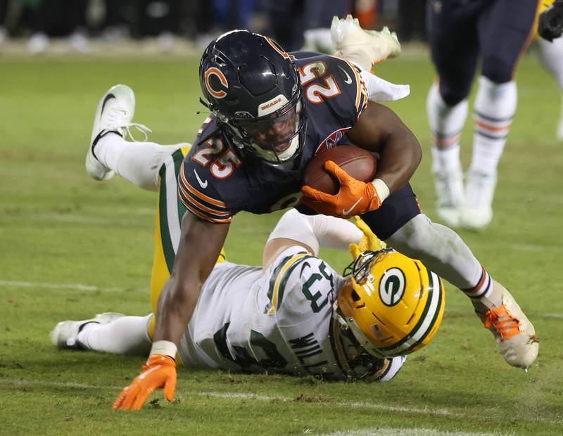 Chicago Bears running back Kyle Monangai dives over Green Bay Packers safety Evan Williams during their NFL Wild Card game Saturday, Jan. 10, 2026, at Soldier Field in Chicago.