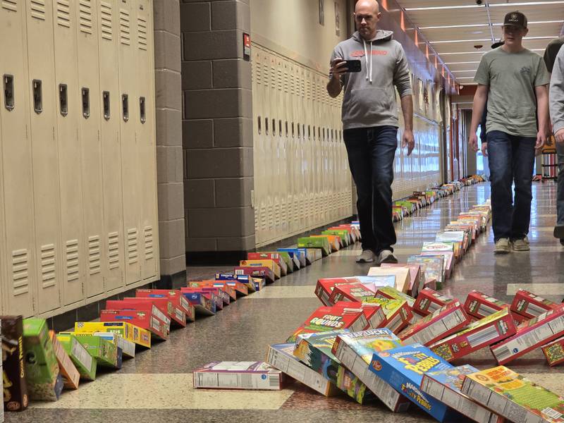 Streator FFA instructor captures on video the cereal boxes as they tumble Tuesday, March 18, 2025, in the hallways of Streator High School.